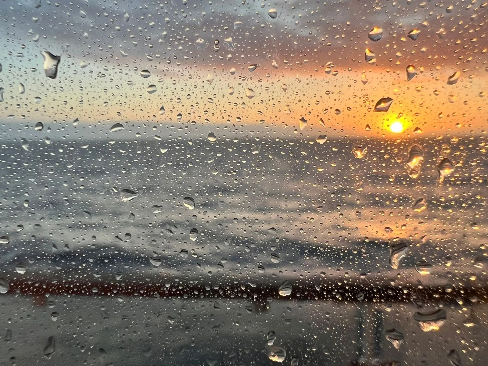 Sunset through a rain-flecked window on the Bay of Biscay, on the overnight run to Santander